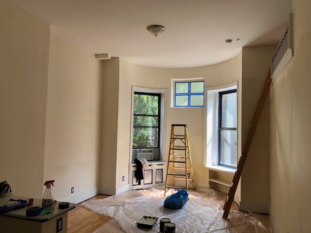 Professional painters discussing project details with clients in NYC.